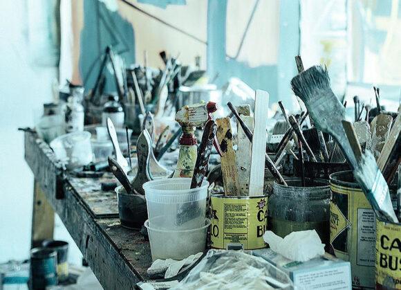 A tableaux of a working artist's table in a painters studio.