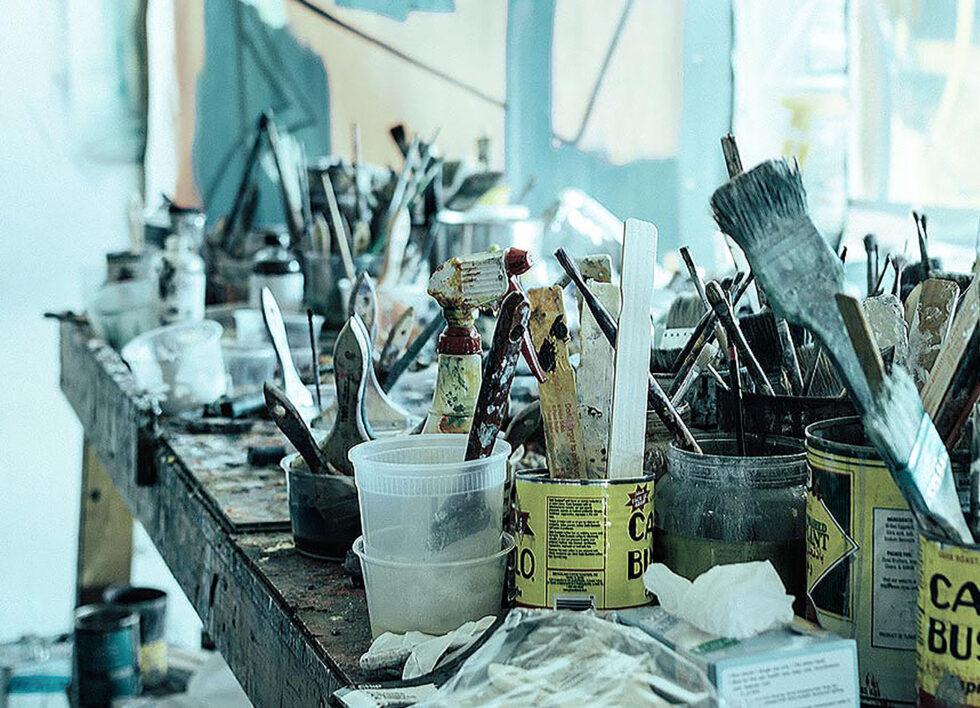 A tableaux of a working artist's table in a painters studio.